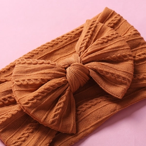 Amber knotted knit nylon headband for baby girls featuring a large decorative bow