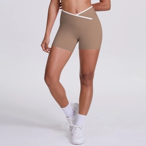 Detail view of high waist yoga shorts featuring a crossover V-shaped white waist design