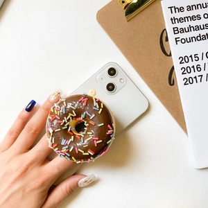 Minimalist chocolate donut phone grip with colorful sprinkles on a white desk