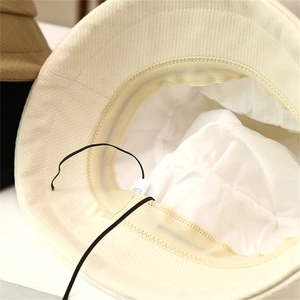 Detail view of foldable bucket hat interior showing inner lining and adjustable drawcord