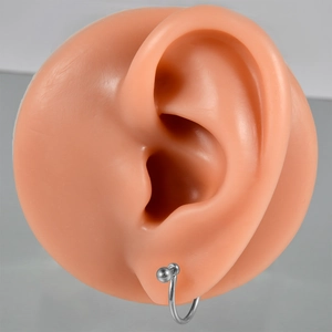 G23 titanium ball closure ring jewelry shown on a silicone ear model for piercing