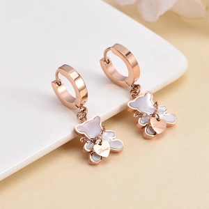 Rose gold bear earrings with white inlay and Love heart charm on white ceramic plate