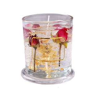 Aromatherapy jelly candle in glass with red rose and gold foil on white background