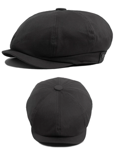 Detailed close-up of dark black newsboy cap showing twill cotton texture and side button