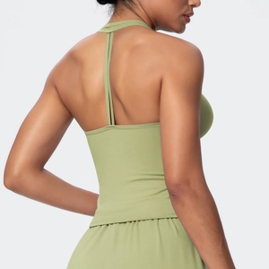 Back view of sage green yoga vest featuring a T-shaped strap design and slim fit