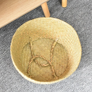Close-up of the woven seagrass belly basket interior showing reinforced texture and base