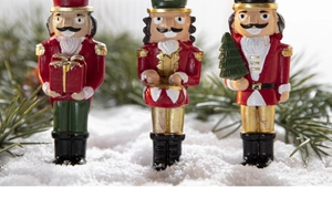Detail view of resin Nutcracker soldier ornaments with festive Christmas tree decorations