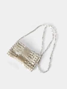 Detail of handcrafted white pearl beaded woven crossbody bag with matching shoulder strap