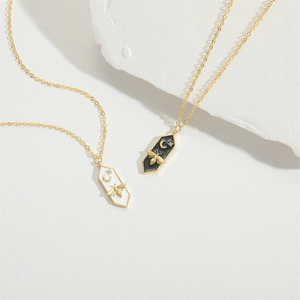 Minimalist gold chain necklace with cute bee and moon pendants in black and white enamel