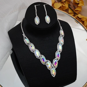 Exquisite bridal jewelry set with AB colored crystals displayed on a black bust stand