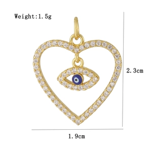 Macro detail of 18K gold plated heart pendant with blue evil eye and zircons