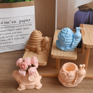 Detailed view of snail and turtle silicone molds used as decorative flower pots