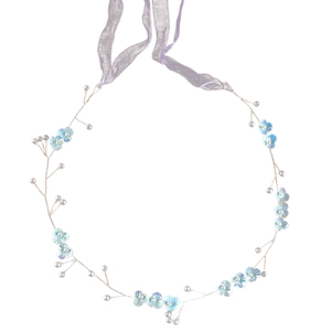 Detail of handcrafted bridal headband with blue petals, pearls and silver wire frame