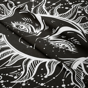 Close-up of black and white bohemian sun and moon tapestry with celestial pattern details