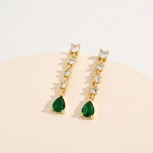Elegant gold drop earrings featuring sparkling zircons and a pear-shaped green gemstone