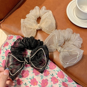 Three rhinestone mesh bow scrunchies in black, beige and grey with elegant design