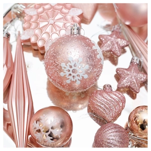 Macro detail of rose gold Christmas ornaments with glitter, snowflakes and varied textures