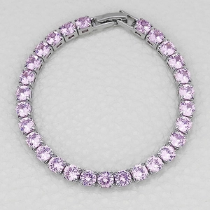 Close-up of pink cubic zirconia tennis bracelet with silver metal four-prong setting