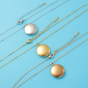 Three round mirror-polished locket necklaces in silver, gold and rose gold tones