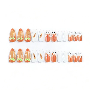 Long almond press-on nails featuring cute orange carrot and rabbit designs on white base