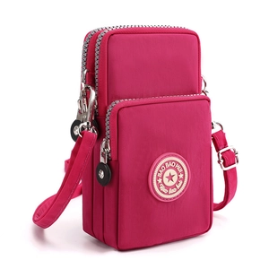 Vertical rose red nylon crossbody phone bag with double zipper and adjustable strap