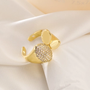 Detail of 18K gold plated irregular ring with pavé zircons on silk background