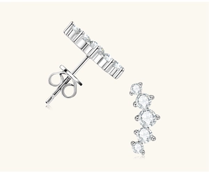 Close-up of 925 sterling silver smile stud earrings with five sparkling white zircons