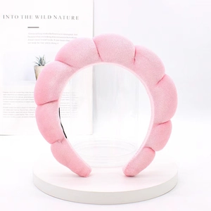 Detail shot of a soft pink padded sponge headband for face washing and SPA routine