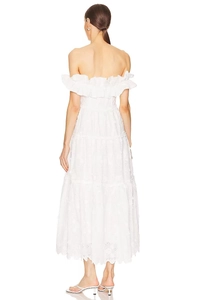 Detail of white off-shoulder lace maxi dress featuring backless design and layered ruffles