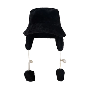 Plush black faux fur bucket hat with ear flaps and decorative pom-poms for winter warmth