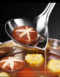 Detailed view of a 304 stainless steel fat separator ladle filtering oil from soup