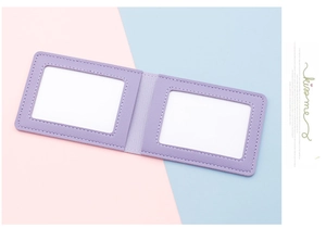 Detail of slim purple faux leather card holder with two transparent ID slots and stitching