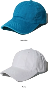 Close-up of deep blue and white washed baseball caps showing fabric texture and stitching