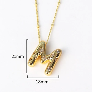 Detailed view of gold M-letter pendant with crystal rhinestones and 21mm size dimensions
