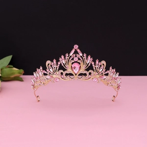 Detailed view of the luxury baroque gold crown with intricate pink rhinestones