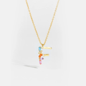 Macro shot of letter F gold pendant necklace featuring colorful rectangular zircons details