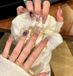 Detalle de uñas largas de ataúd con mariposas 3D y grandes gemas púrpuras