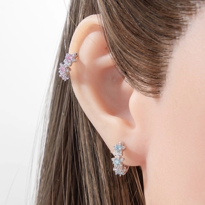 Silver flower earrings and ear cuff with colorful cubic zirconia on model's ear