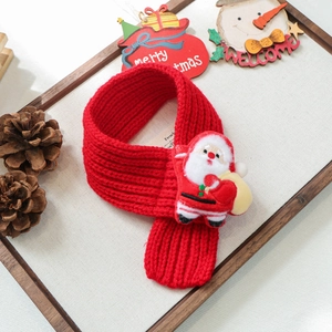 Detail of red knit pet scarf with a 3D Santa Claus figure for dogs and cats