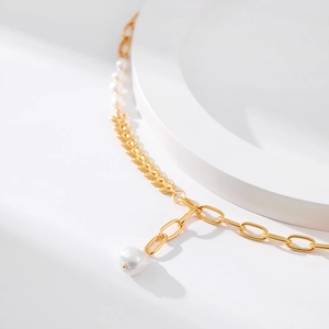 Vintage 18K gold plated wheat ear chain necklace with elegant white pearls on a tray