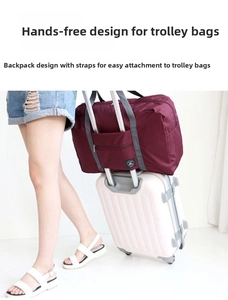 Detail of burgundy travel bag with trolley sleeve attached to a pink luggage handle