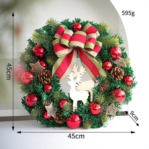 Close-up of Christmas wreath showing red ornaments, pine cones and wooden reindeer