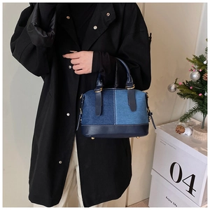 Close-up of a denim patchwork mini tote bag shown in a stylish lifestyle setting