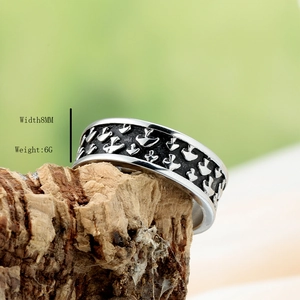 Retro 8mm silver and black stainless steel ring for men displayed on rustic wood