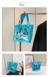 Close-up of blue transparent tote bag with black butterfly prints and fabric handles