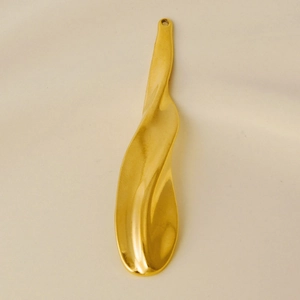 Macro view of gold 304 stainless steel wavy pendant with irregular geometric design