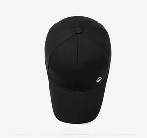 Top view of minimalist black baseball cap showing the six-panel design and metal detail