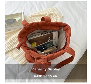 Rust red quilted canvas tote bag with a matching pouch showing spacious interior storage