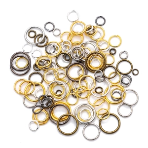 Mixed sizes of colorful metal jump rings for handmade DIY jewelry making on white background