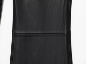 Close-up of black leather pants showing detailed texture and high-quality horizontal stitching